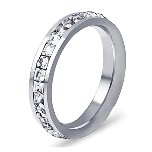 Macro detail of silver ring featuring channel-set square-cut zircon stones on band