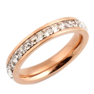 Detail of rose gold eternity ring with channel-set square cubic zirconia crystals