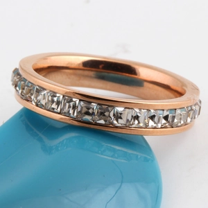 Macro shot of rose gold ring featuring a single row of square-cut clear cubic zirconia stones