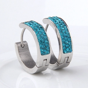 Detail of stainless steel hoop earrings with three rows of teal blue crystals inlay
