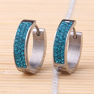Detailed shot of silver huggie earrings with triple-row inlaid sky blue crystals