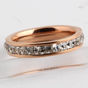 Macro detail of 4mm rose gold eternity ring with channel-set square-cut cubic zirconia
