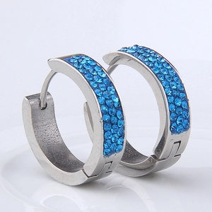 Macro shot of silver stainless steel hoop earrings with three rows of royal blue crystals