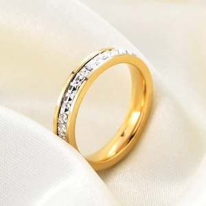 Elegant 4mm gold plated ring with square white cubic zirconia stones on silk fabric