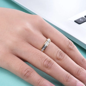 Golden 4mm single row square zircon ring displayed on a hand in a modern office setting