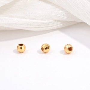 Macro shot of three gold-plated S925 sterling silver faceted laser beads for DIY jewelry