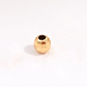Detailed macro view of faceted gold-plated S925 sterling silver laser beads for jewelry DIY