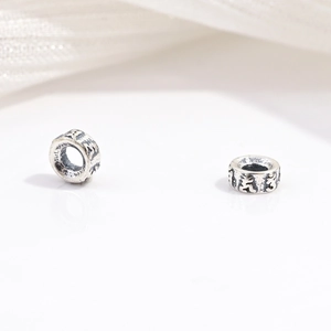 Close-up of S925 sterling silver spacer beads with vintage ethnic patterns for DIY jewelry