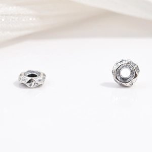 Macro shot of vintage S925 sterling silver faceted gear beads for DIY jewelry