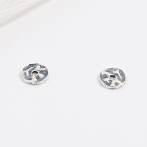 Macro detail of S925 sterling silver hammered spacer beads for DIY jewelry making