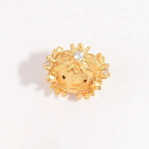 Detailed side view of golden snowflake charm bead with white zircons for DIY jewelry