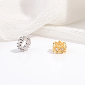 Close-up of S925 silver baguette cut zircon spacer beads and golden crown charm detail