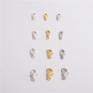 Macro view of silver and gold plated S925 lobster clasps for jewelry DIY in various sizes