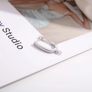Detailed macro view of S925 sterling silver earring hook with inlaid cubic zirconia stones