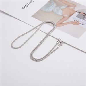 Elegant S925 sterling silver corn chain necklace with lobster clasp on studio background