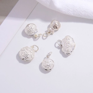 Macro shot of five S925 silver lucky charms including lock and bag for DIY jewelry