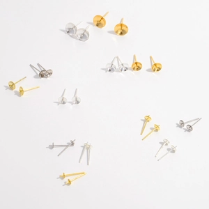 Macro view of gold and silver S925 sterling silver earring studs with bowl cup settings