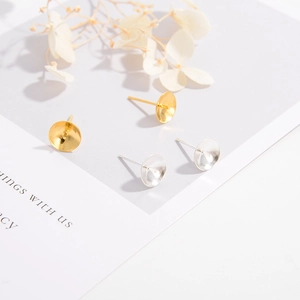 Detail of silver and gold-plated earring cup and peg settings for DIY jewelry making