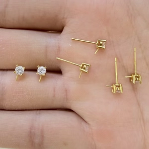 Close-up of S925 sterling silver gold-plated earring studs with four-prong cubic zirconia