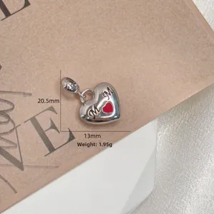 Macro view of S925 silver MOM heart charm with red enamel detail and size dimensions