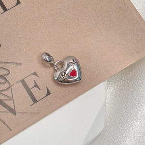 Detail showing an S925 sterling silver MOM heart charm with a red enamel heart detail