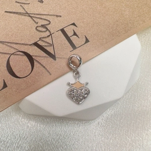 Macro shot of silver S925 heart pendant with crown detail and pavé cubic zirconia