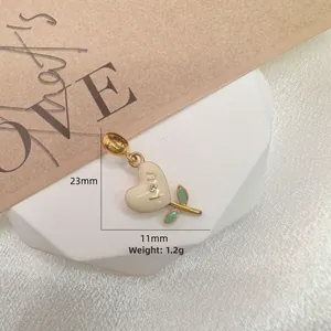 Macro shot of S925 silver heart pendant with enamel finish, green leaves and I U engraving