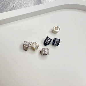 Macro detail of S925 silver and black pave zircon spacer beads with hanging loops