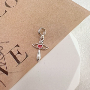 Detailed close-up of S925 silver angel heart pendant with red enamel and wings