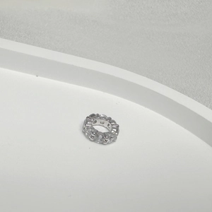 Macro detail of S925 sterling silver gear bead with sparkling cubic zirconia stones