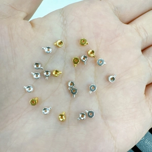 Close-up of gold and silver S925 sterling silver crimp beads for jewelry making