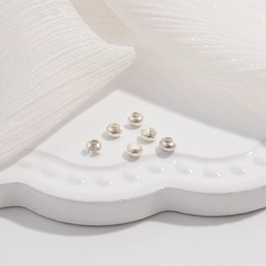 Macro view of 6 pieces S925 sterling silver crimp bead covers for DIY jewelry making
