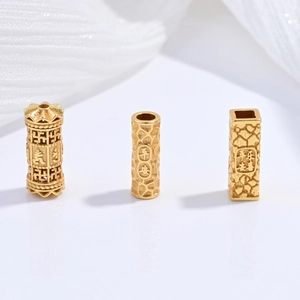 Macro detail of S925 sterling silver gold-plated charms with Ping An lucky engravings