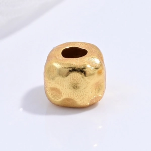 Macro view of gold hammered texture S925 sterling silver barrel bead for DIY jewelry