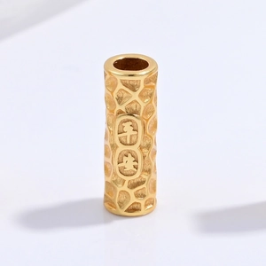 Macro shot of S925 silver cylinder bead with Ping An engraving and textured finish