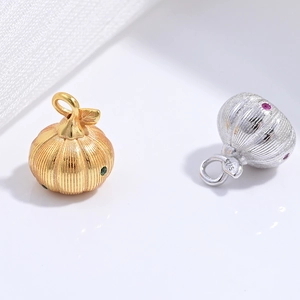 Macro detail of S925 sterling silver pumpkin pendants with gold and silver plating