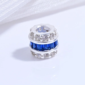 Macro shot of S925 silver charm bead with white zirconia and blue crystal layers