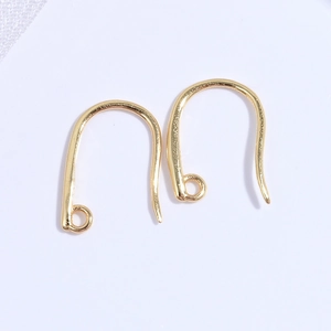 Detail shot of pair of polished gold-finished U-shape earring hooks with ring connectors