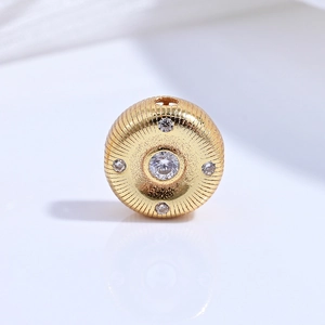 Detailed macro view of S925 gilded bead with radial texture and CZ inlay for DIY jewelry