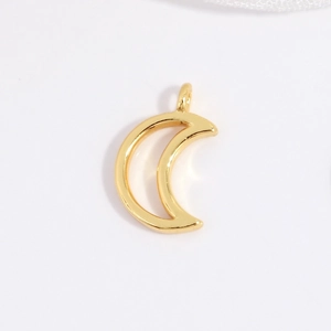 Close-up of a polished gold crescent moon pendant charm for DIY jewelry making