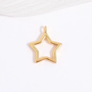 Macro detail of a hollow star-shaped gold pendant with integrated loop for DIY jewelry