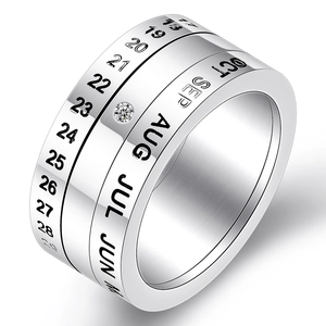 Rotatable stainless steel calendar ring with high polish finish and center stone inlay