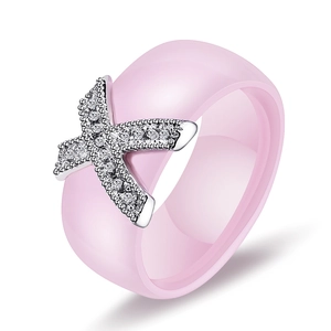 Pink ceramic ring with silver X-shape design and sparkling cubic zirconia stones