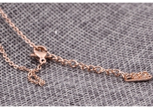 Detailed macro view of the rose gold necklace clasp and S925 sterling silver hallmarked tag