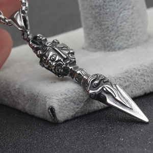 Macro view of retro stainless steel vajra pendant with detailed relief and silver finish