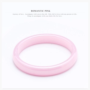 Detailed view of a semi-transparent romantic pink ceramic ring with a polished round band