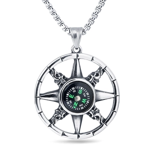 Detail of vintage compass pendant in stainless steel with a green scale on box chain