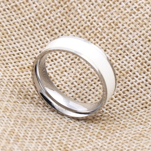Top view of 7mm silver stainless steel ring with white enamel inlay on burlap texture