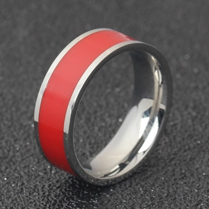 Detail of 7mm stainless steel ring with polished silver edges and red enamel inlay
