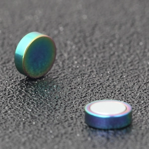 Dettaglio macro di orecchini magnetici arcobaleno per lobi non forati in forma cilindrica
